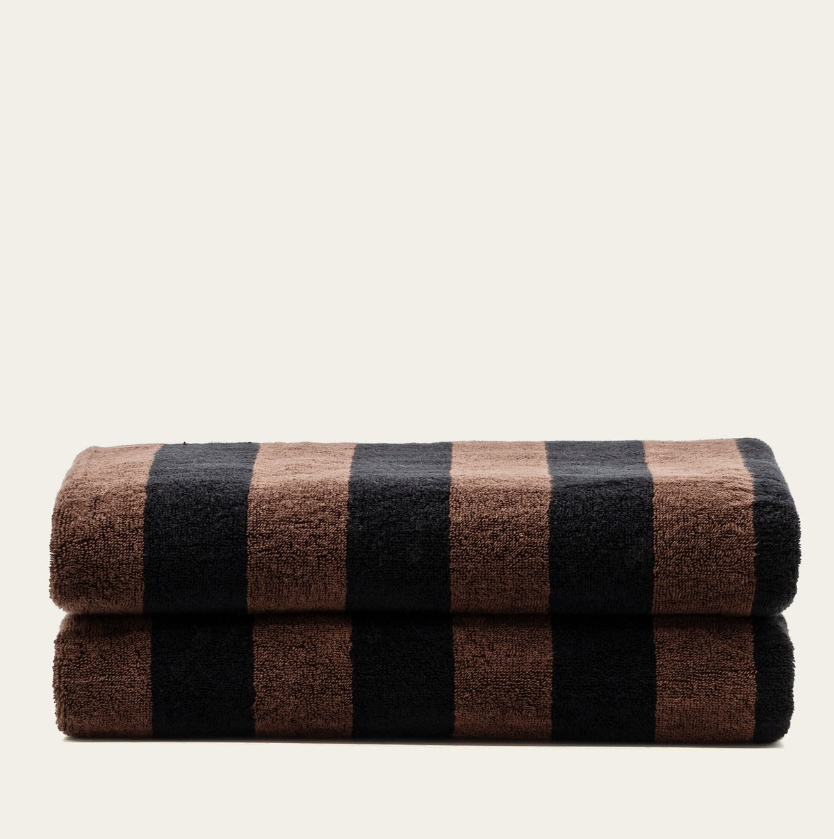 Tobacco and black checkered towels folded into two rolls