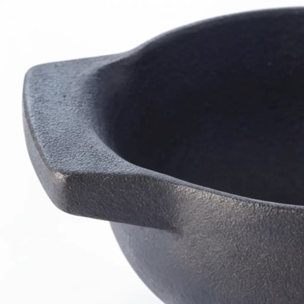 Black enameled mortar bowl with textured interior and curved rim