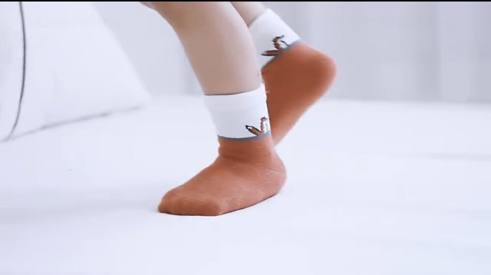 Toddler socks on a child’s foot: orange crew with fox emblem on the cuff