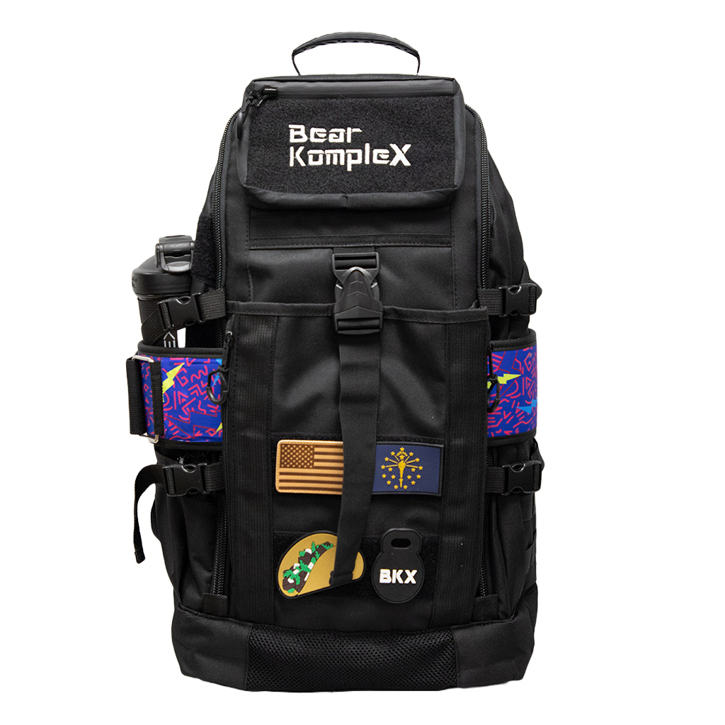 Black tactical backpack with top handle, front flap pocket, and colorful side panels