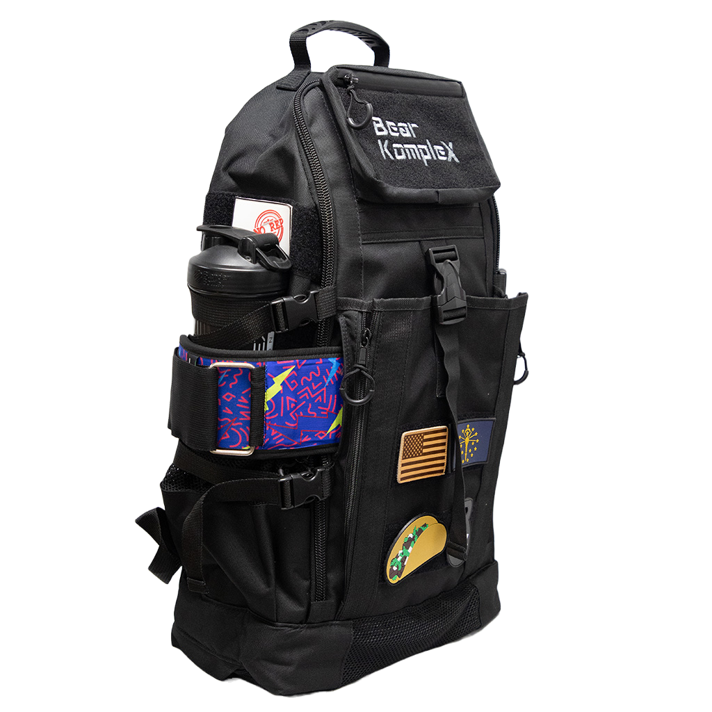 Black tactical backpack with front zip pocket, side elastic bottle holders, and patches