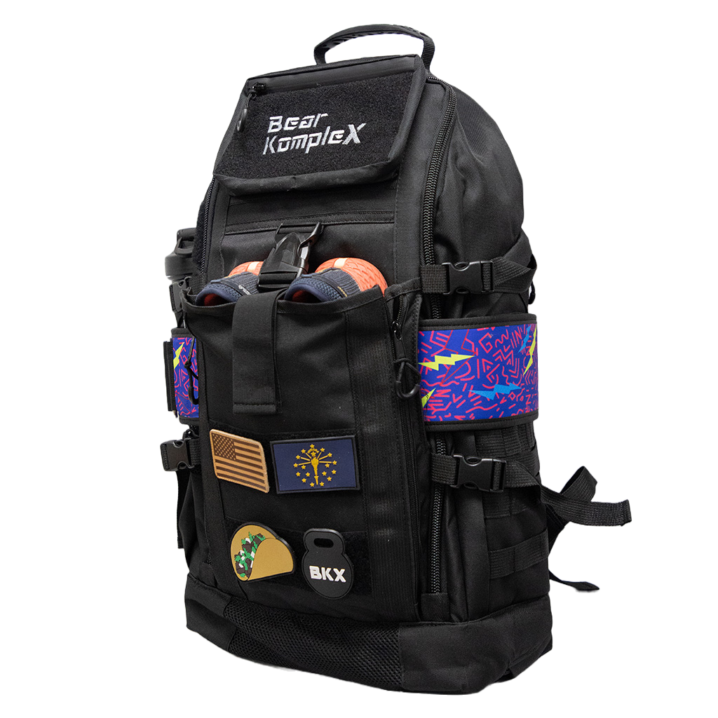 Black tactical backpack with front organizer pocket, side straps, and colorful panel