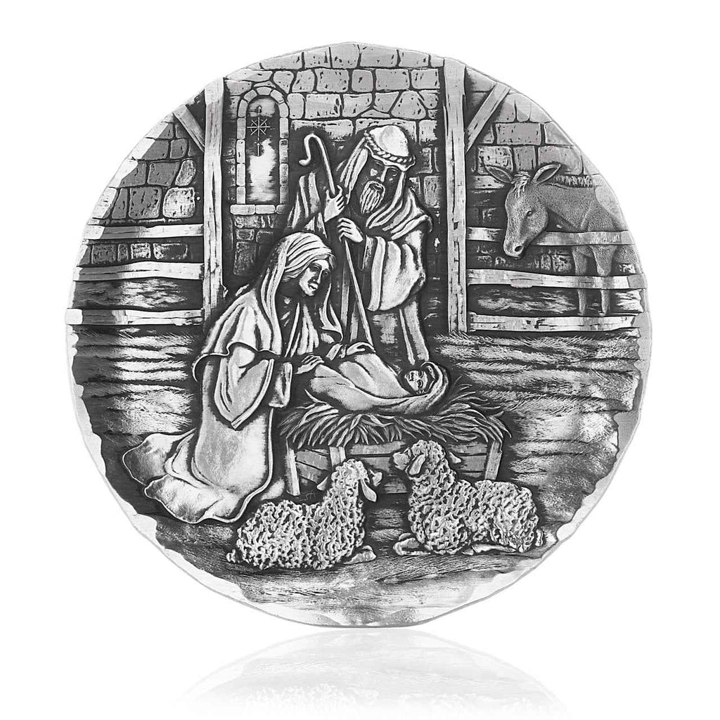 Round coaster with black-and-white nativity scene engraving of Mary, Joseph, and baby