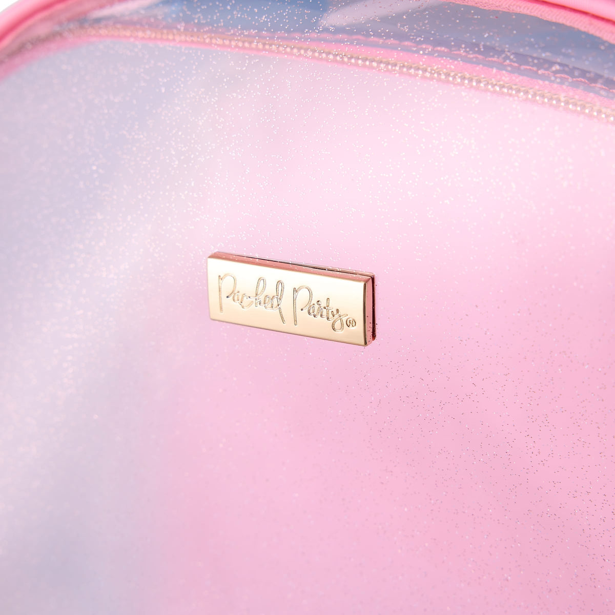 Close-up pink clear front panel with gold nameplate tag on jelly material