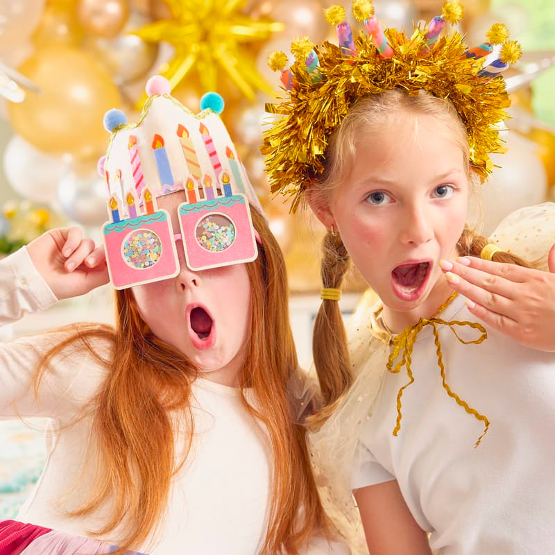 Gold tinsel birthday candle headband with rainbow printed candle sleeves and pom-poms