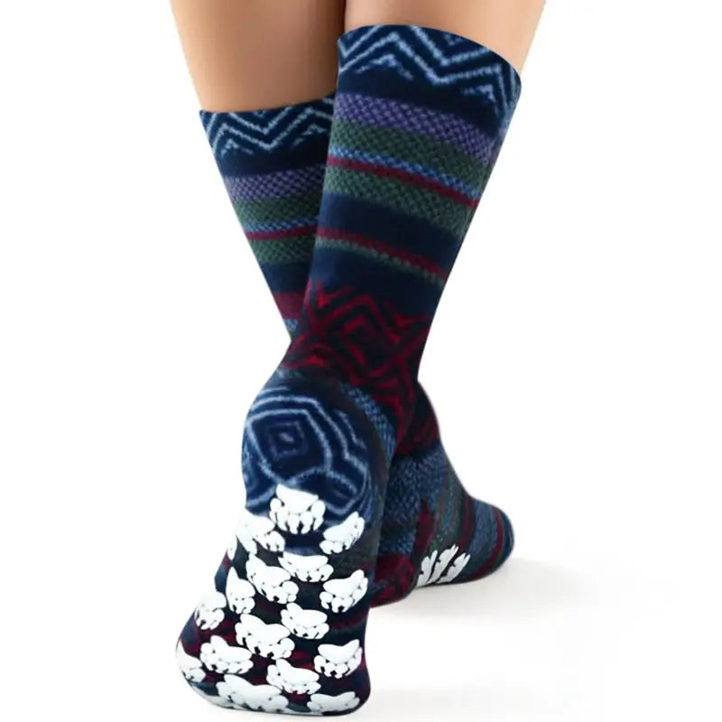 Fleece crew socks showing paw-print grippy sole, dark blue Nordic pattern with red and green