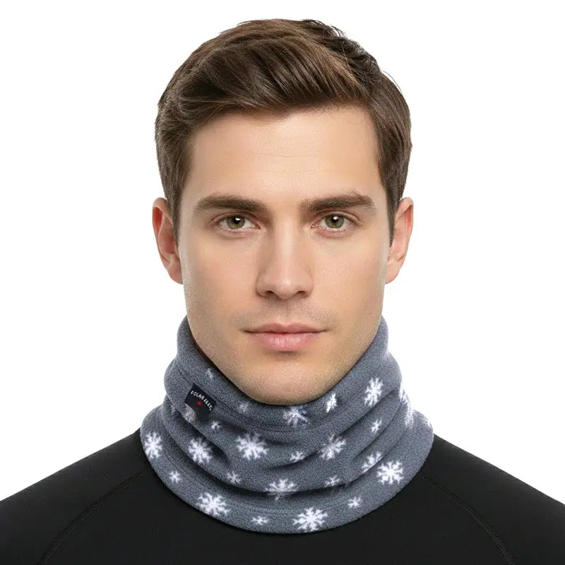 Fleece neck warmer on model: dark gray with white snowflake print, cozy close fit
