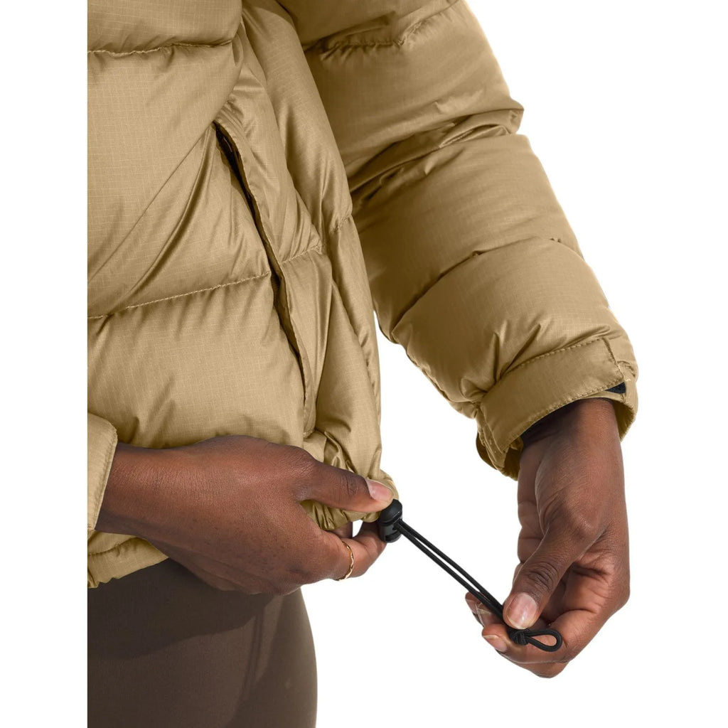 Women’s khaki puffer jacket cuff and zipper pull detail, quilted insulation