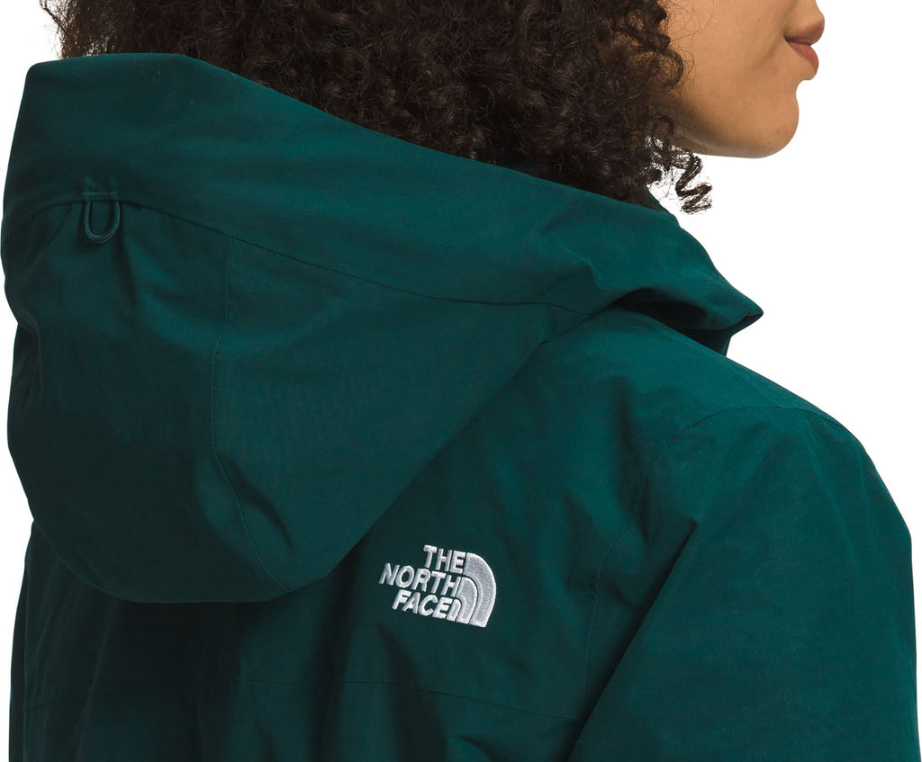 Women’s dark teal Arctic Parka close-up of The North Face logo and hood trim