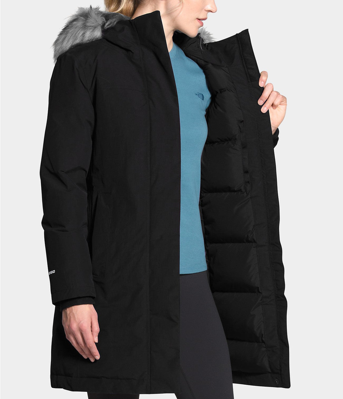Women’s black Arctic Parka showing blue inner lining and faux-fur hood trim