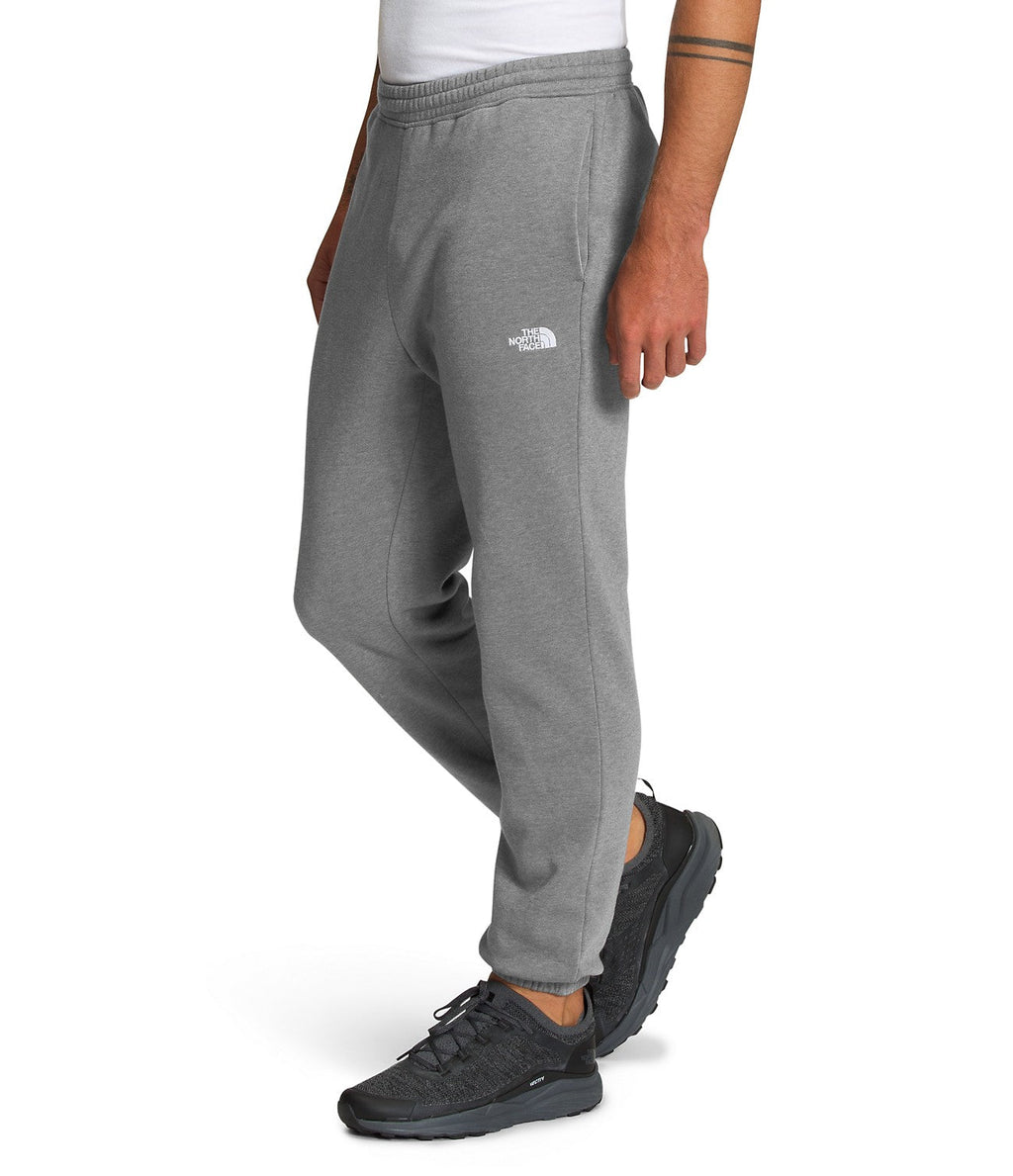 Men's grey heather sweatpants with small TNF logo on thigh and tapered cuffs