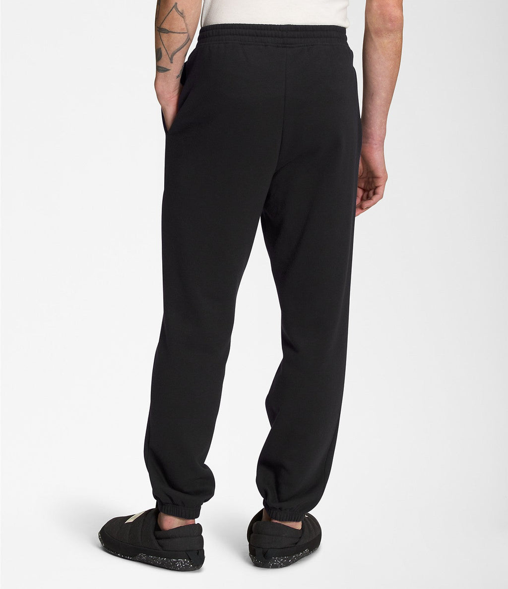 Men's black sweatpants with elastic waistband and tapered ankle cuffs