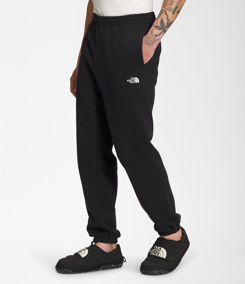 Men's black sweatpants with small TNF logo on thigh and tapered ankle cuffs