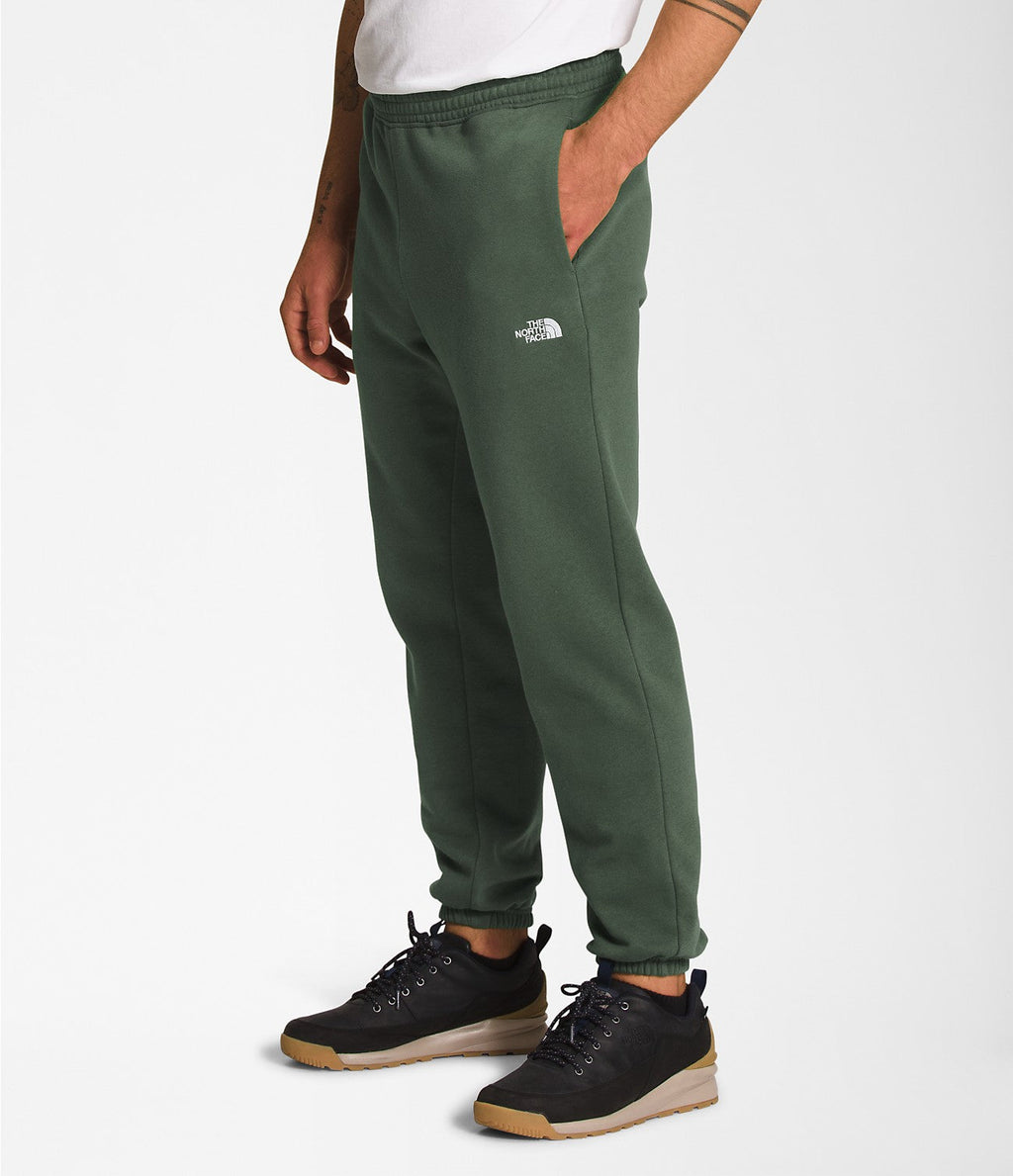 Men's thyme green sweatpants with small TNF logo on thigh and tapered ankle cuffs