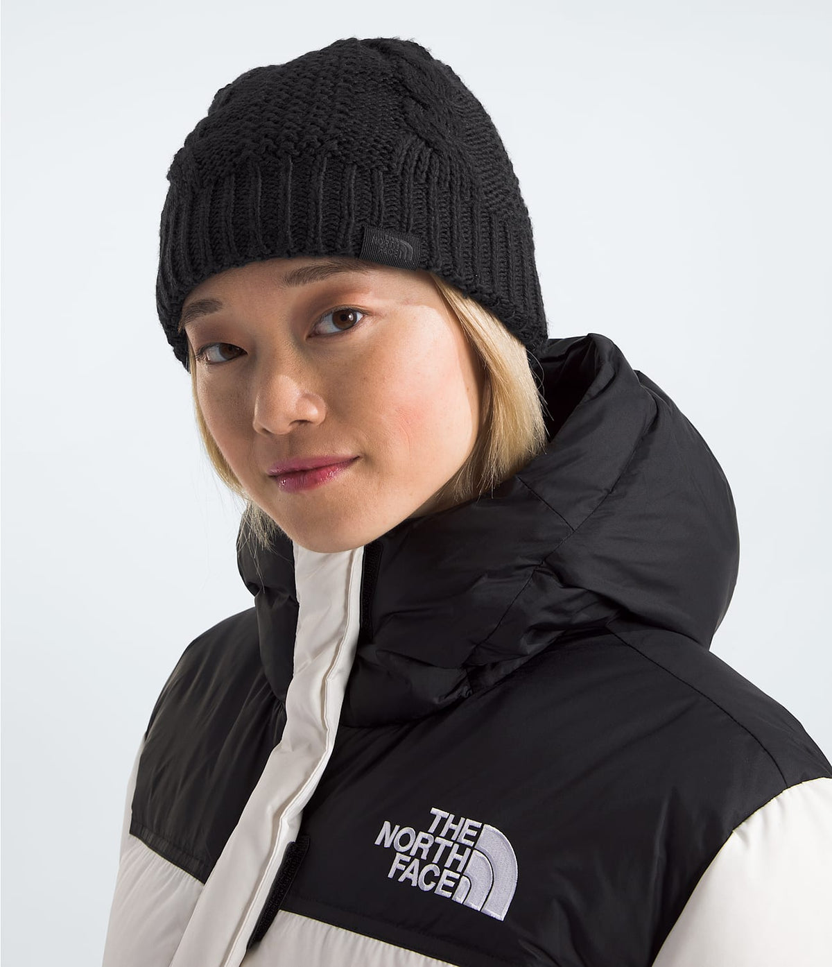 Black knit beanie with cable pattern and ribbed cuff