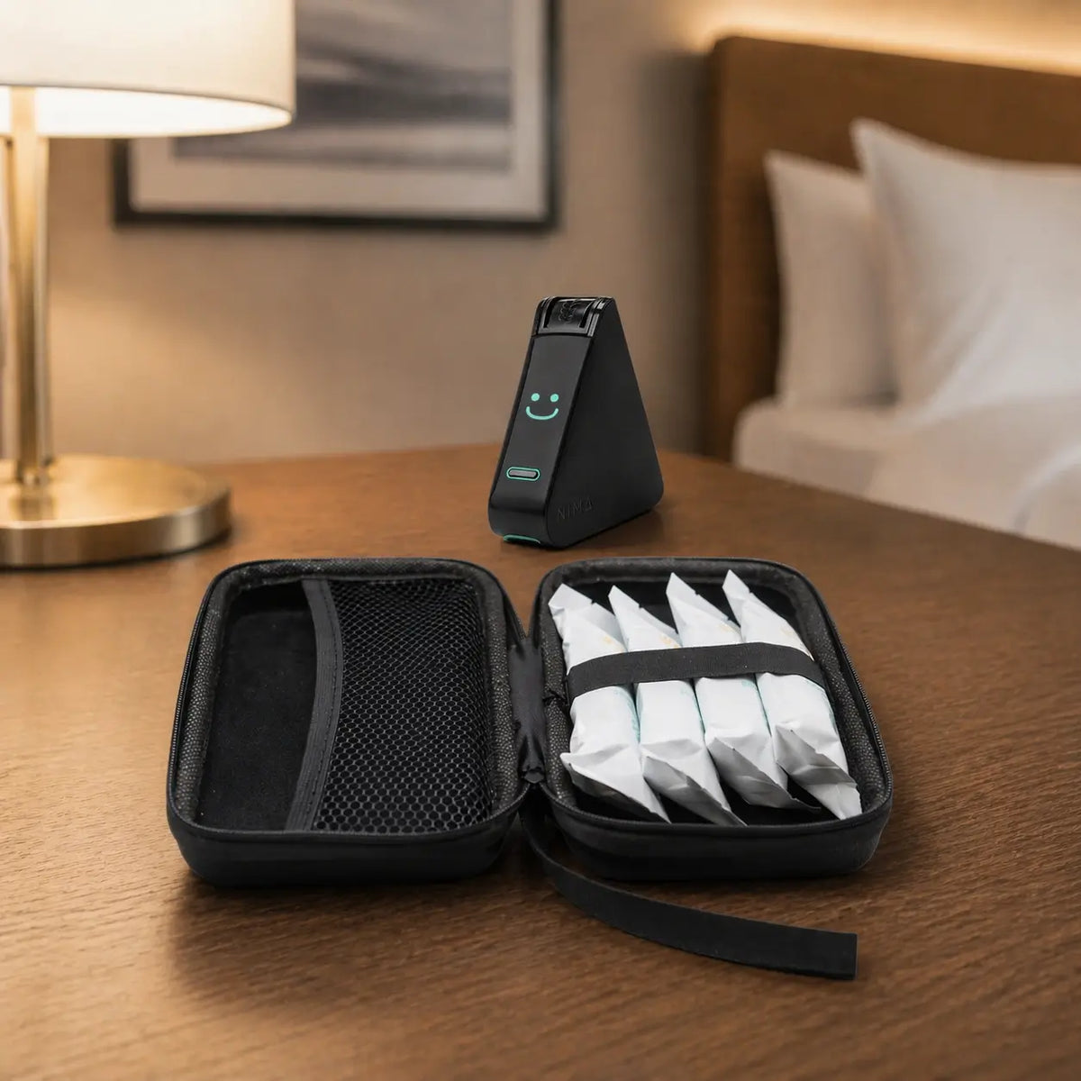 Black travel case set on table, open with mesh divider and wipes inside