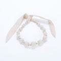 Ivory polka-dot fabric beaded necklace with dangling ribbon bows