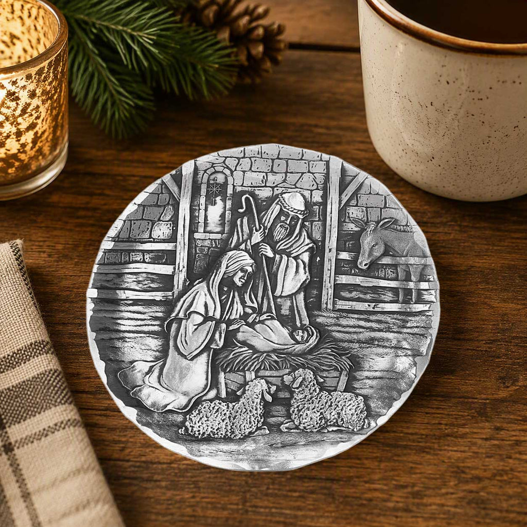 Round coaster featuring a black-and-white nativity scene in an arched stone doorway