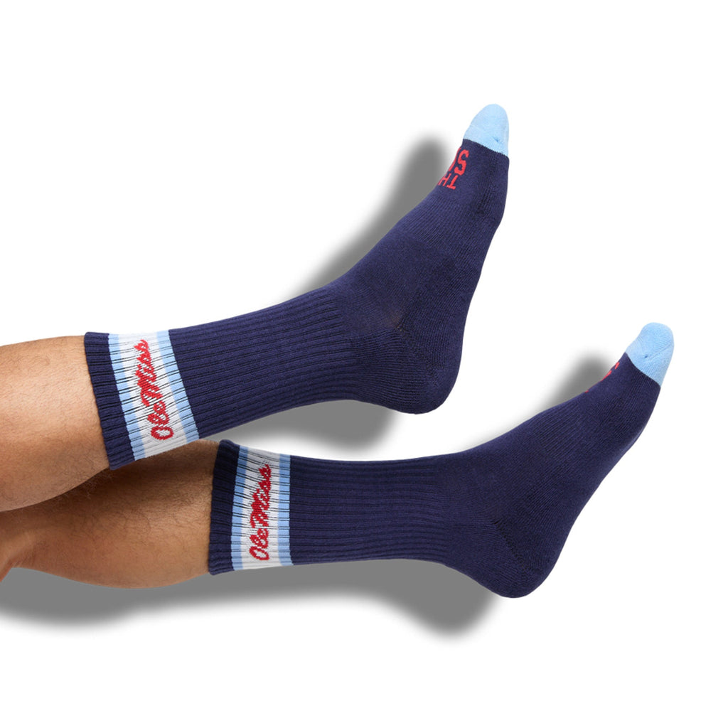 Navy crew socks with white/red striped band and red script logo on the cuff