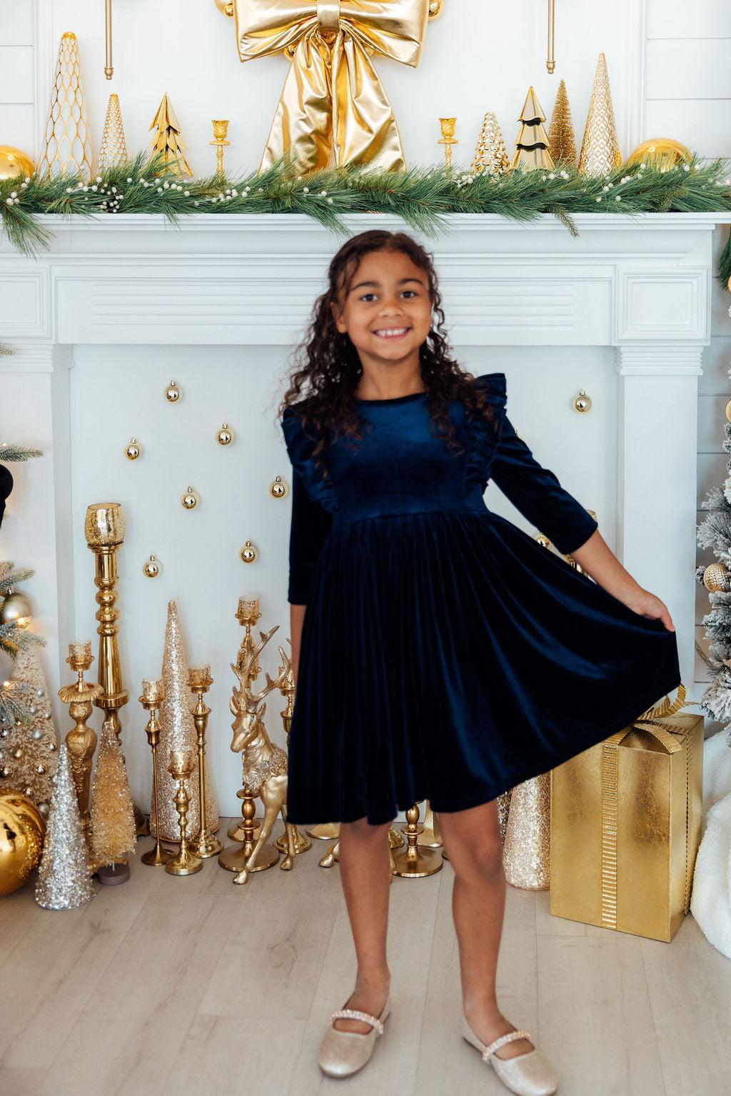 Girls navy velvet ruffle twirl dress with flared skirt, ruffle sleeves, and gathered waist