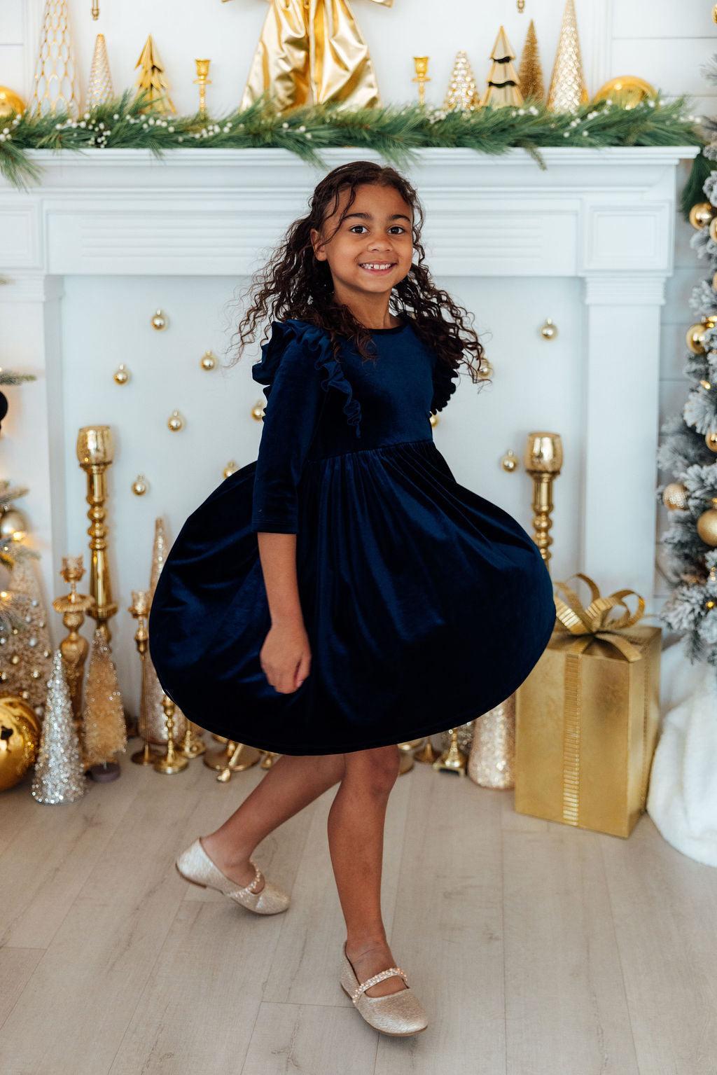 Girls navy velvet ruffle twirl dress with flared skirt and ruffled shoulder detail