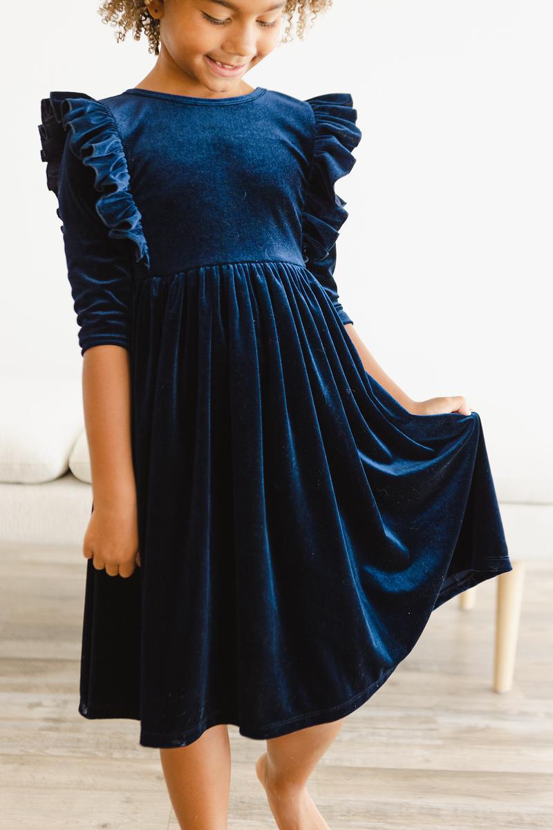 Girls navy velvet ruffle twirl dress with flared skirt and gathered waist, front view