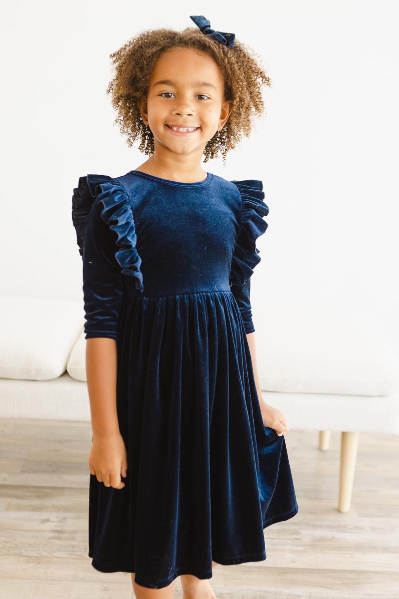 Girls navy velvet ruffle twirl dress with three-quarter puff sleeves and gathered waist