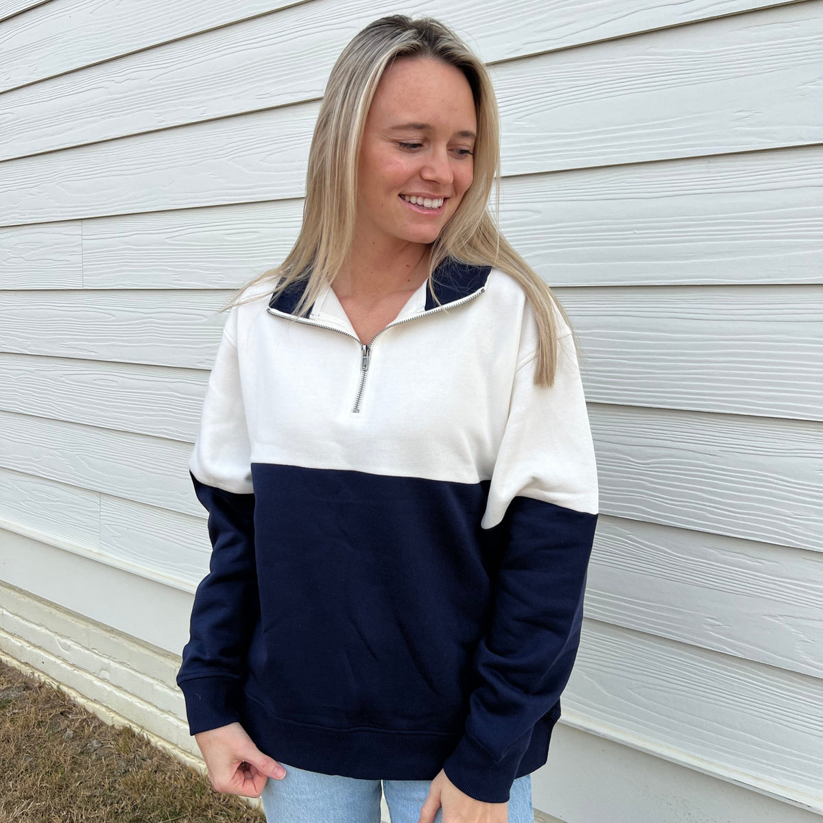 Colorblock quarter-zip pullover with white and navy blocks, stand collar