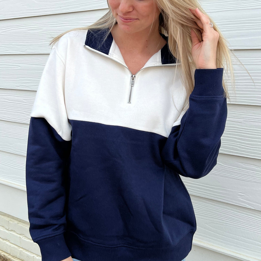 White-and-navy colorblock quarter-zip pullover with long sleeves and zip collar