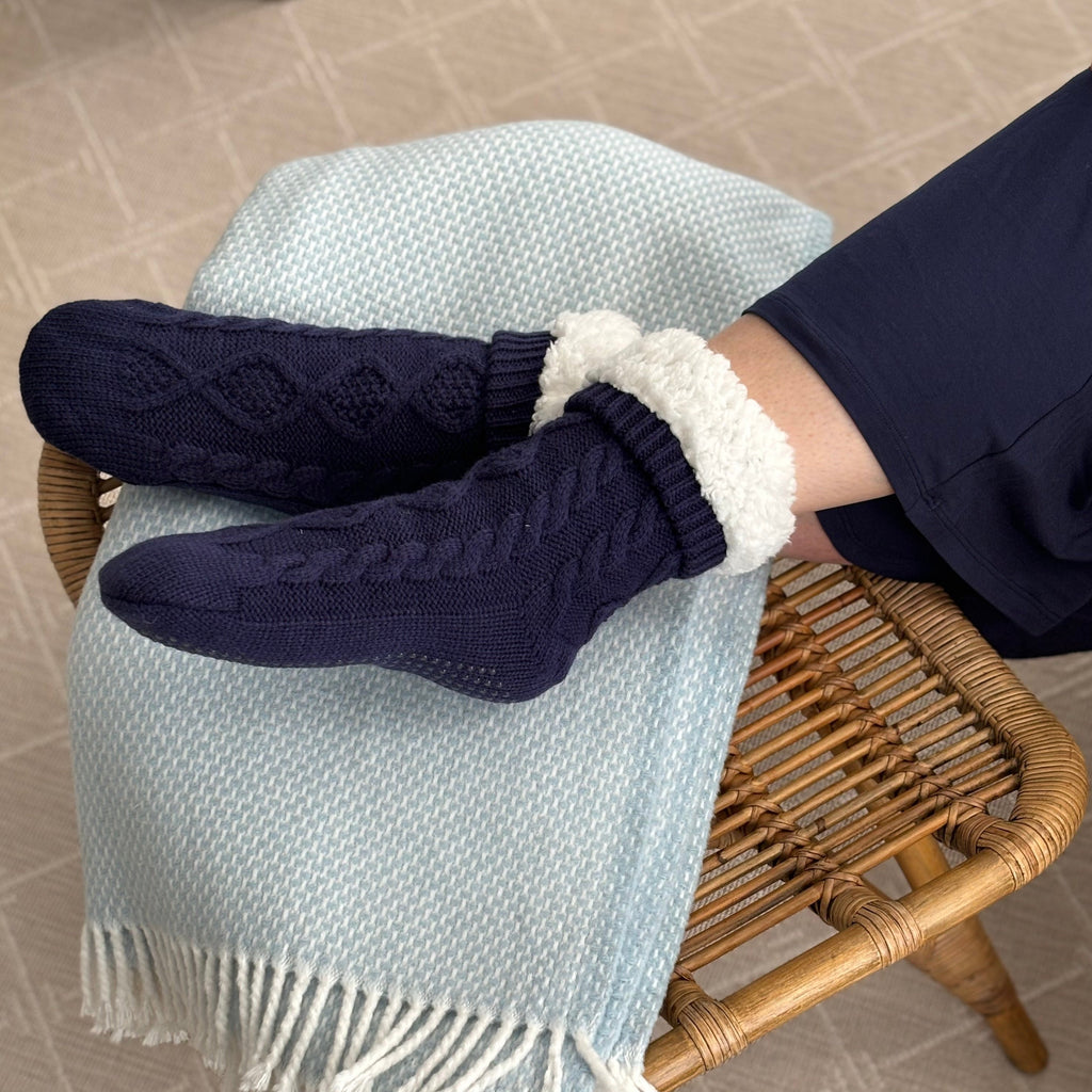 Navy slipper socks with sherpa cuffs and textured non-slip sole