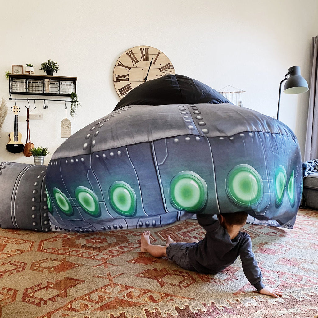 Inflatable UFO play tent in dark gray with green circular lights and padded dome