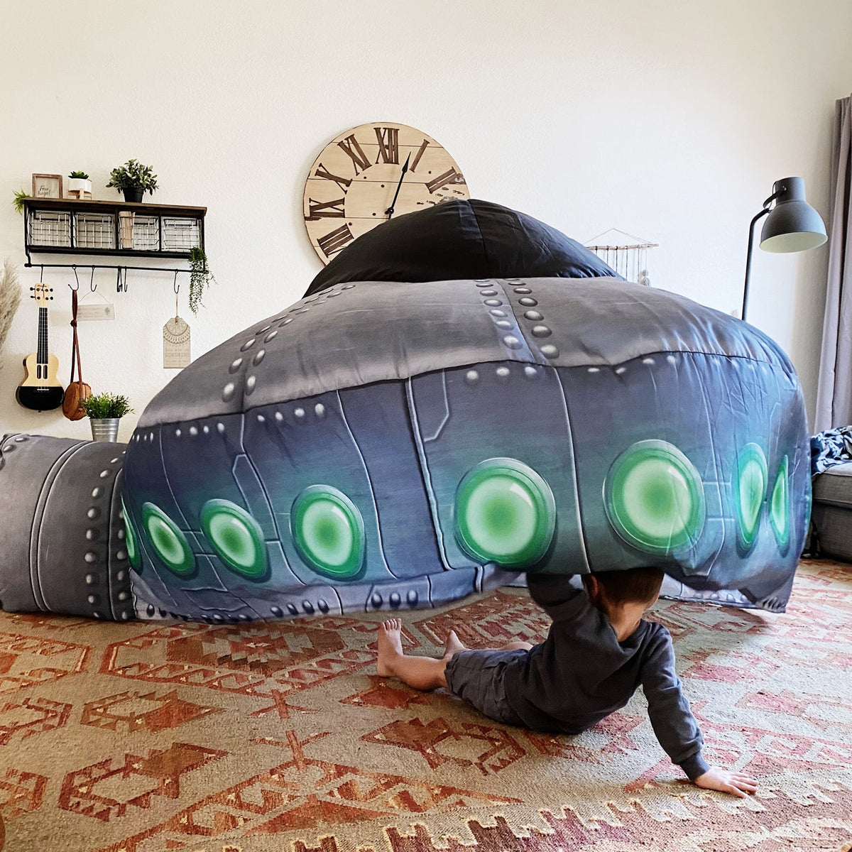 Inflatable UFO play tent in dark gray with green circular lights and padded dome