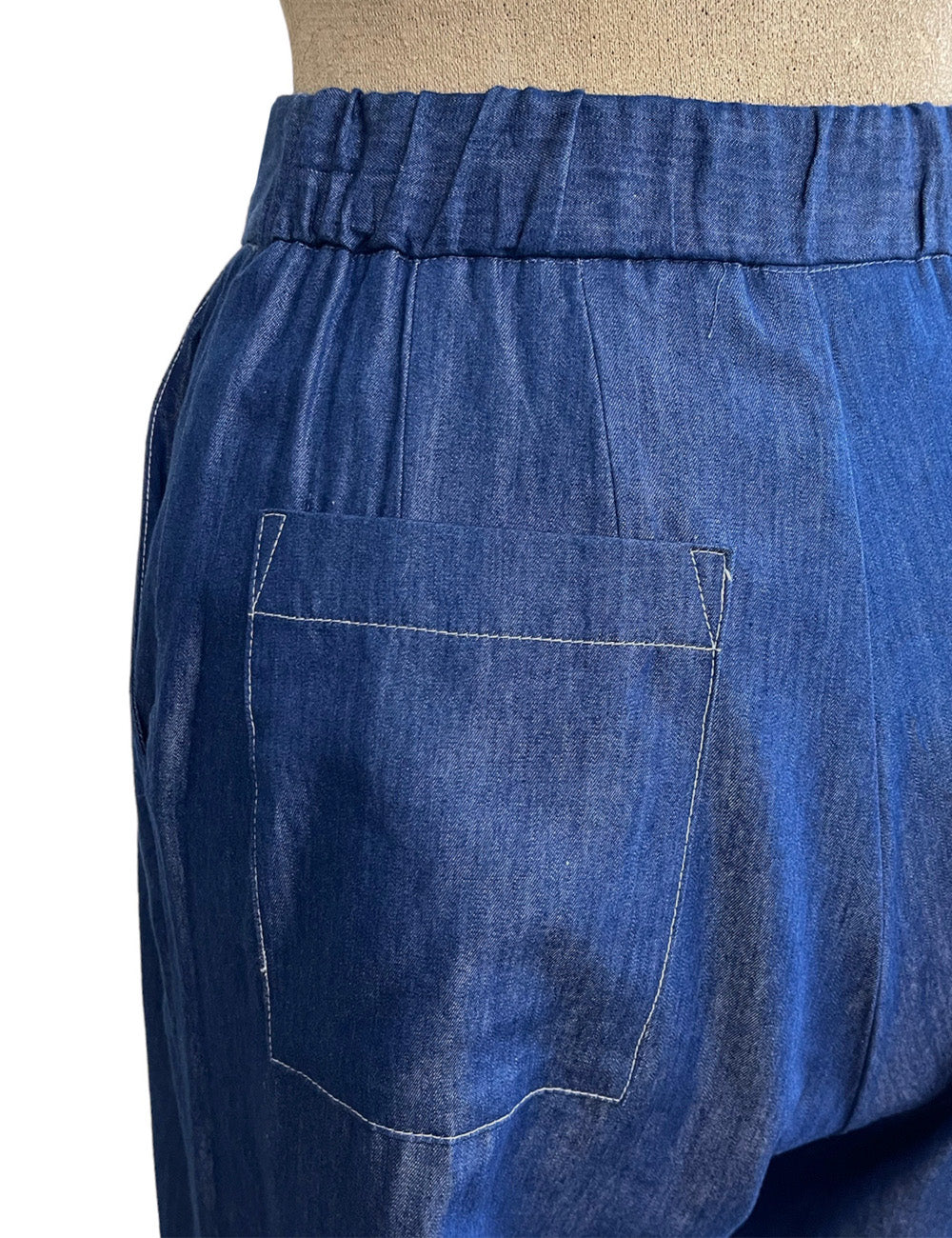 High-waist dark blue chambray denim trousers with side pockets and belt loops