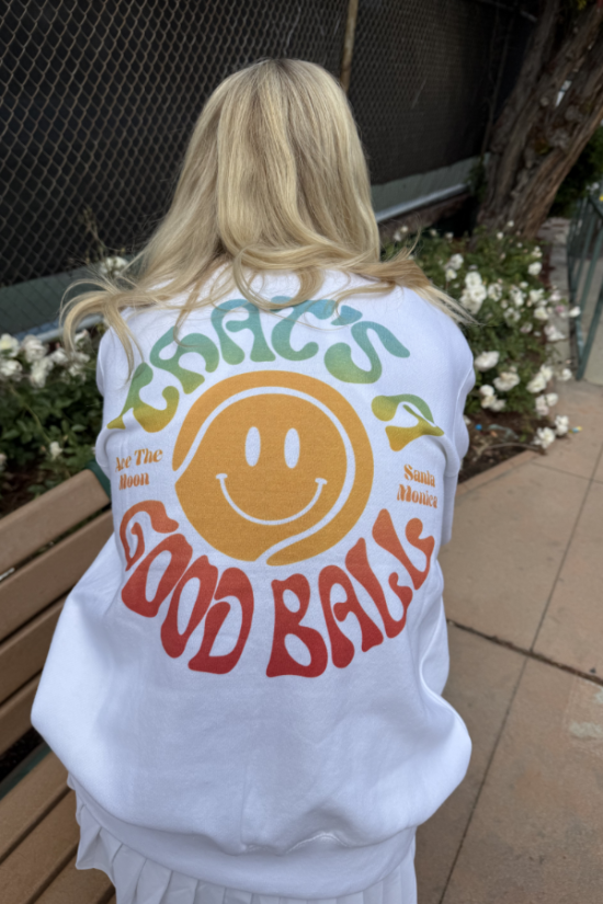 White crewneck sweatshirt with large back smiley face graphic and multicolor lettering