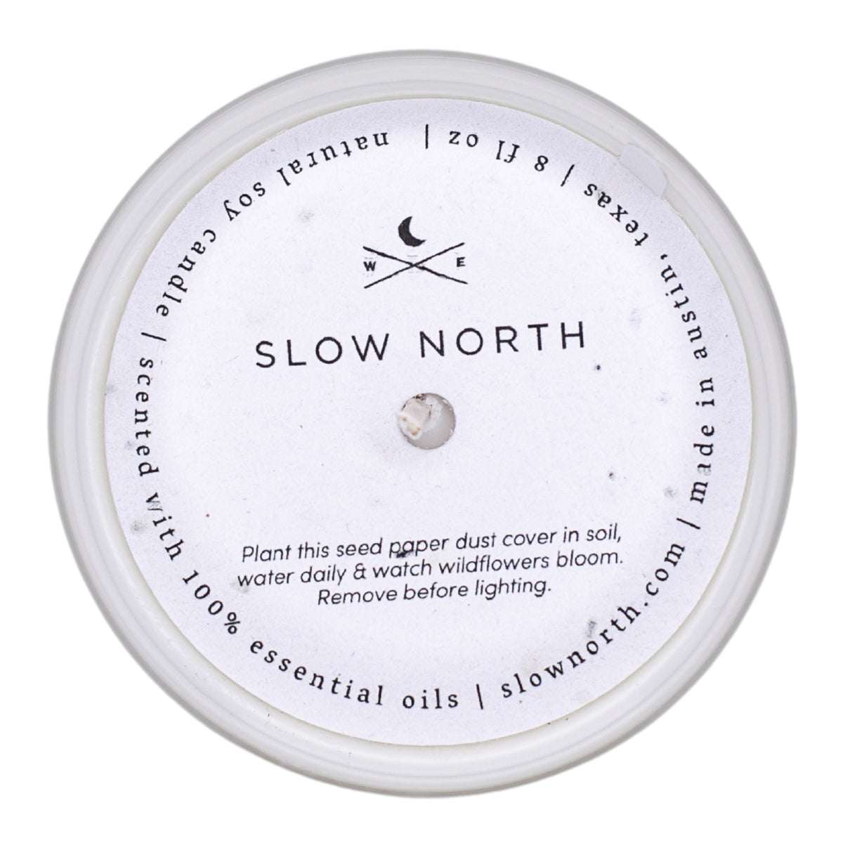 Soy candle lid with seed-pod care instructions and small central emblem