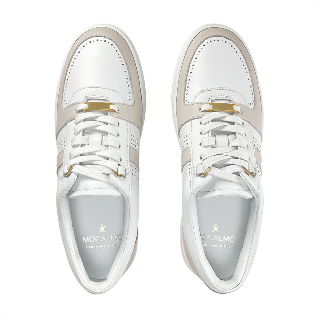 Pair of women’s ivory and gray sneakers with gold-stud lace detail on the tongue