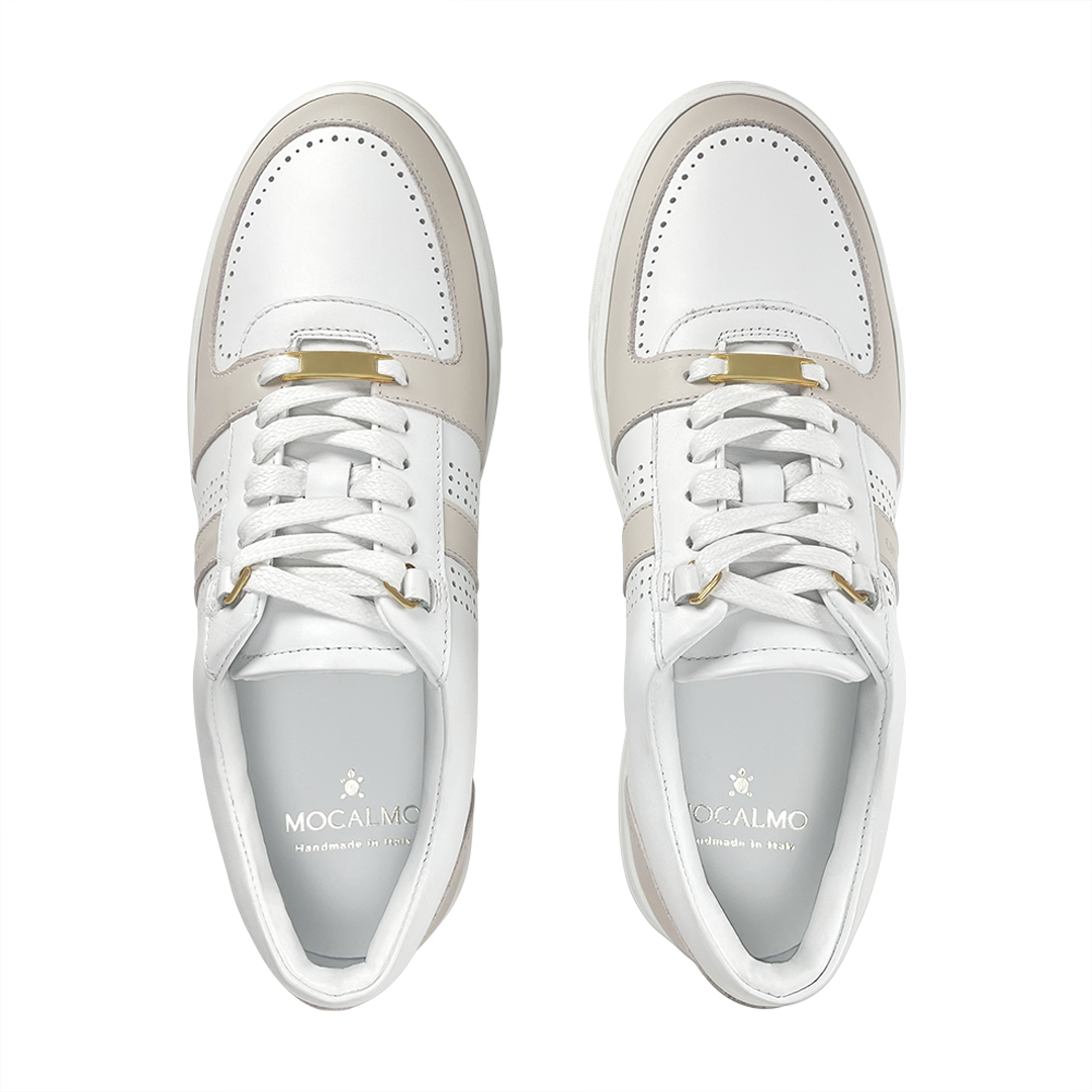 Pair of women’s ivory and gray sneakers with gold-stud lace detail on the tongue