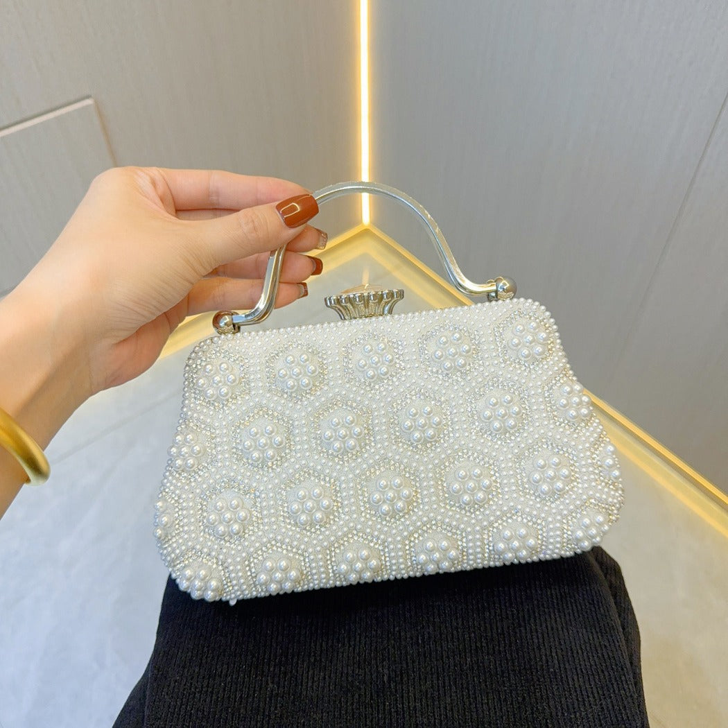 White embellished pearl clutch with top handle, studded round faux-pearl accents
