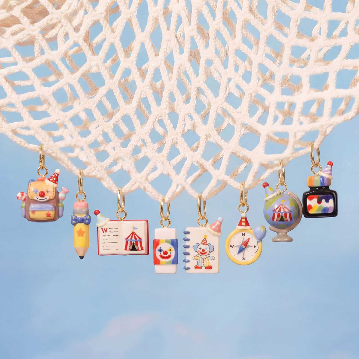 Hanging set of miniature school-supply keychain charms with gold rings