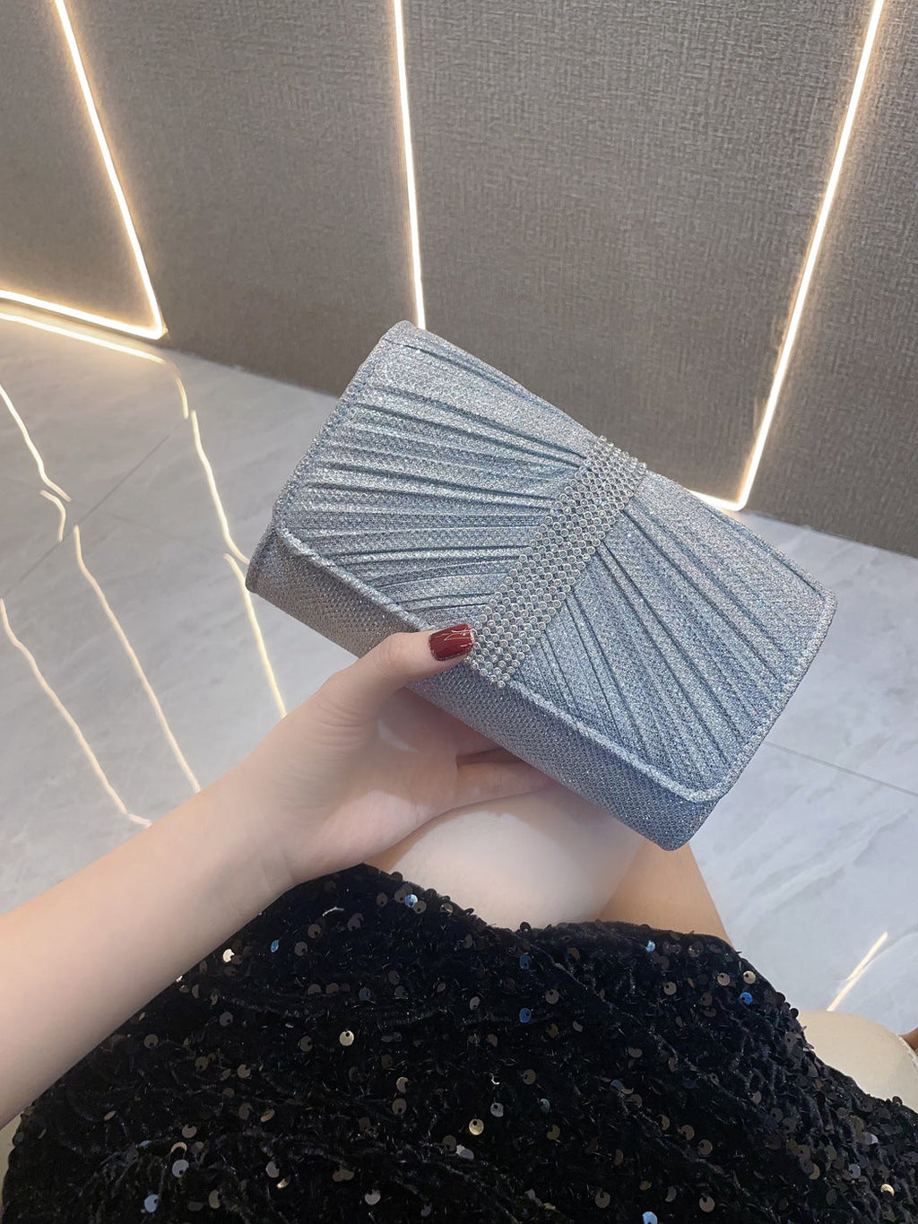 Light blue diamond-textured clutch handbag with white stripe and top clasp