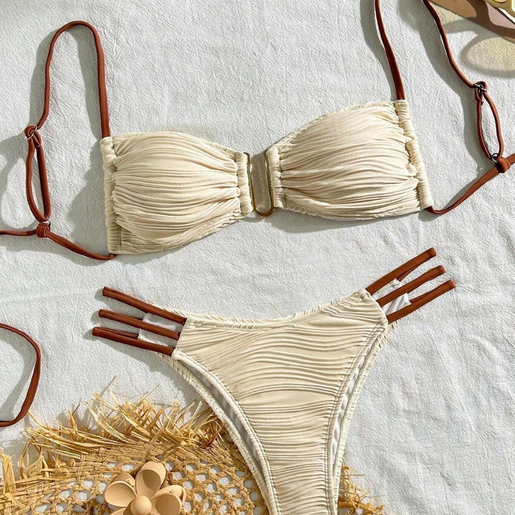 Ivory ruched bandeau bikini top with thin brown tie straps and gold clasp