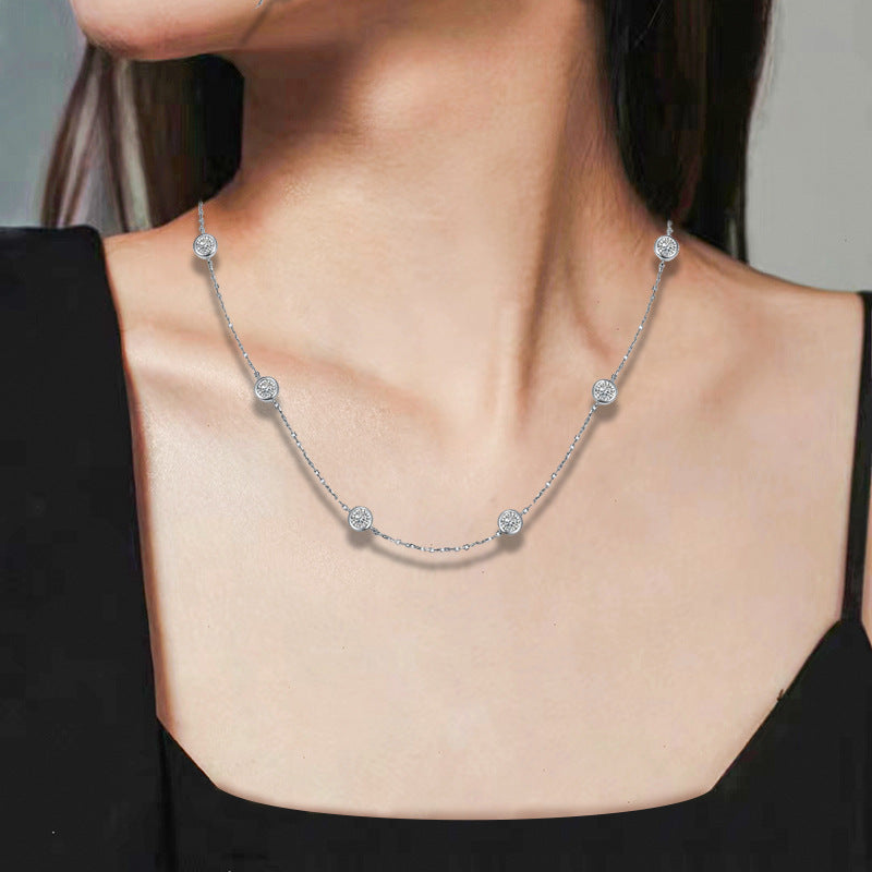 Moissanite bubble necklace with small round stones, worn at the neckline
