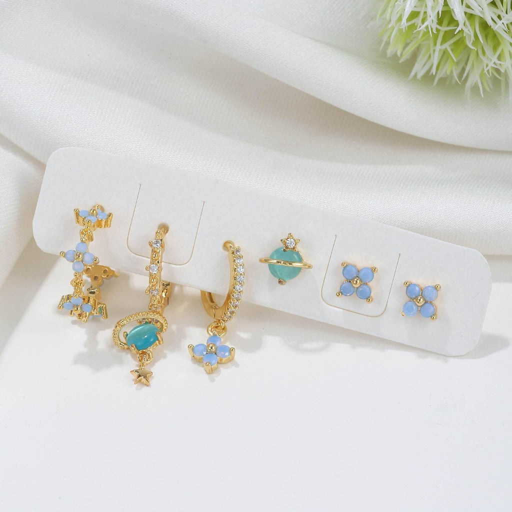 Earring set organizer card with gold-tone blue flower and teal charm drops