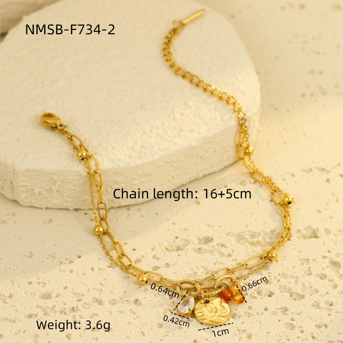 Gold-tone chain bracelet with heart medallion charm and blue bead drop