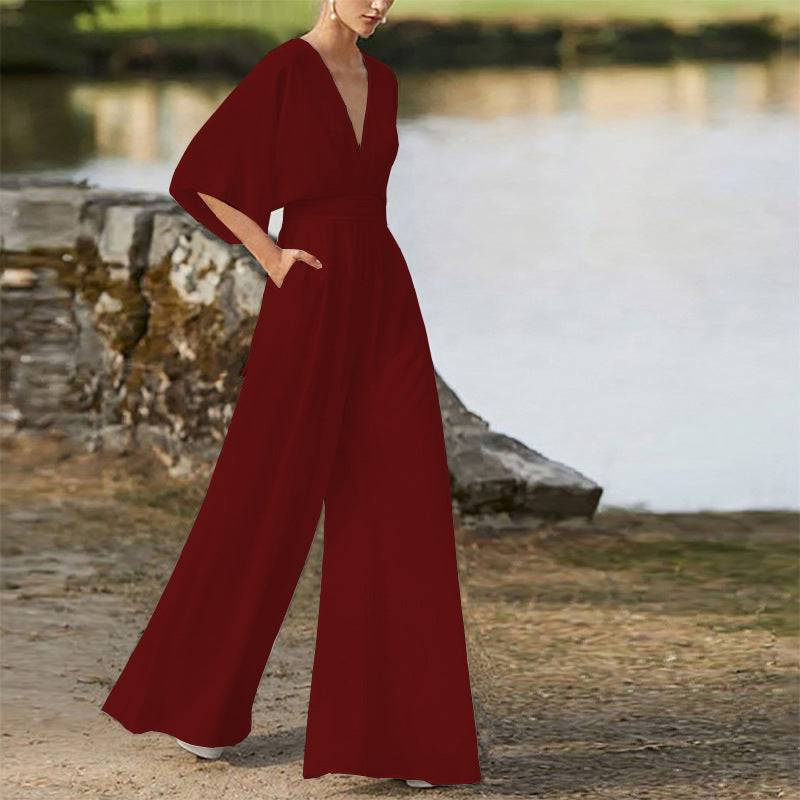 Side-view red wide-leg jumpsuit dress with deep V neckline and high waist