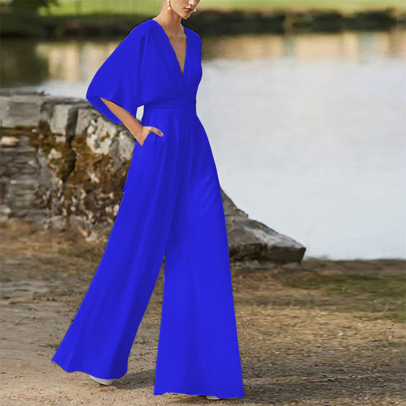 Blue wide-leg jumpsuit dress with deep V neckline, high waist, dolman sleeves