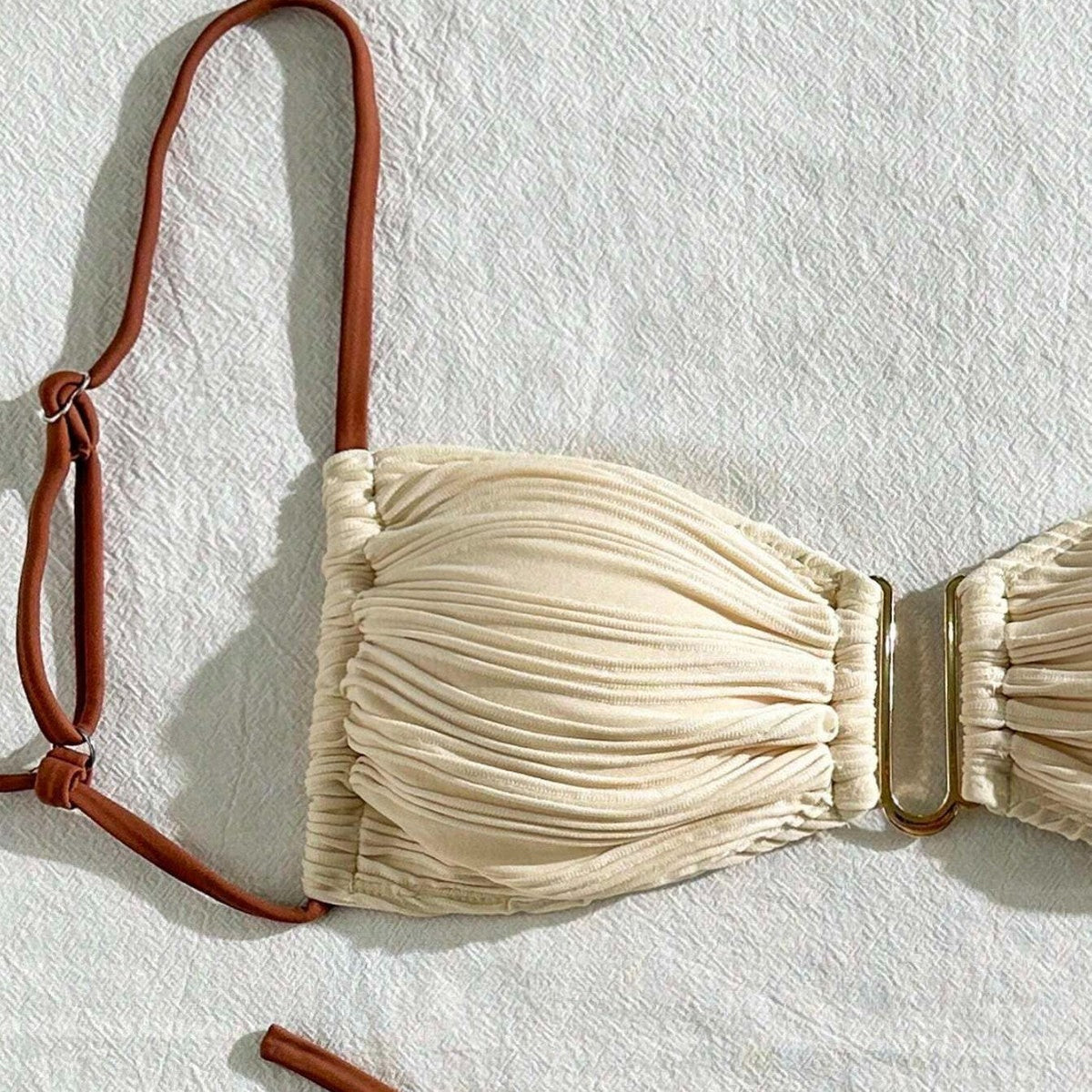 Ivory ruched bandeau bikini top close-up with brown adjustable neck strap