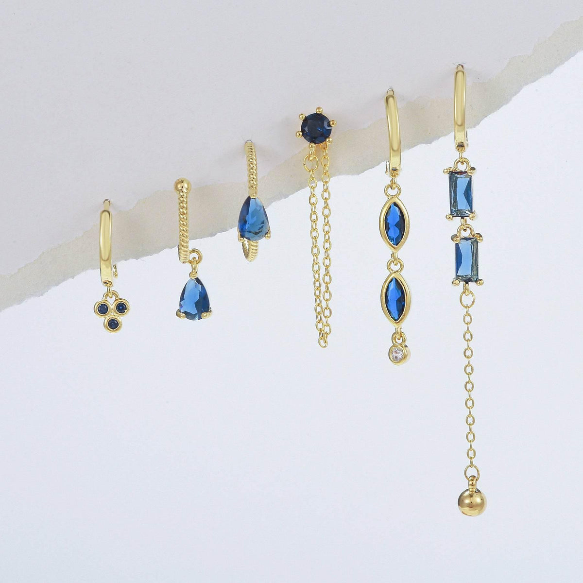 Gold-tone long drop earrings with blue stones and fine chain tassels