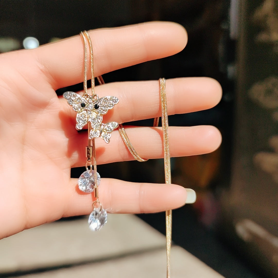 Silver-tone butterfly pearl chain necklace with dangling charms