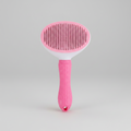 Pink self-cleaning slicker brush with oval spiked head and textured non-slip handle